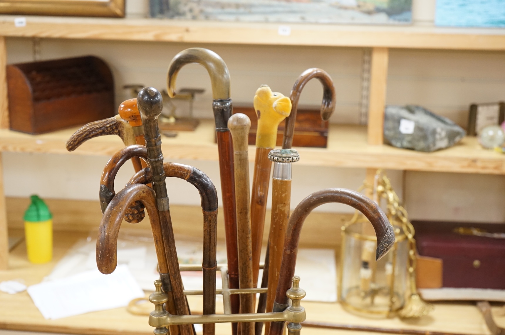 A collection of various walking sticks, some silver mounted and a brass stick stand, 67cm high